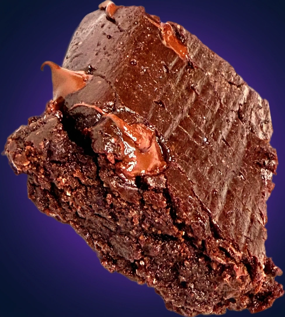 A fudgy, gooey Lifemaxx protein brownie, fresh from a small-batch bake